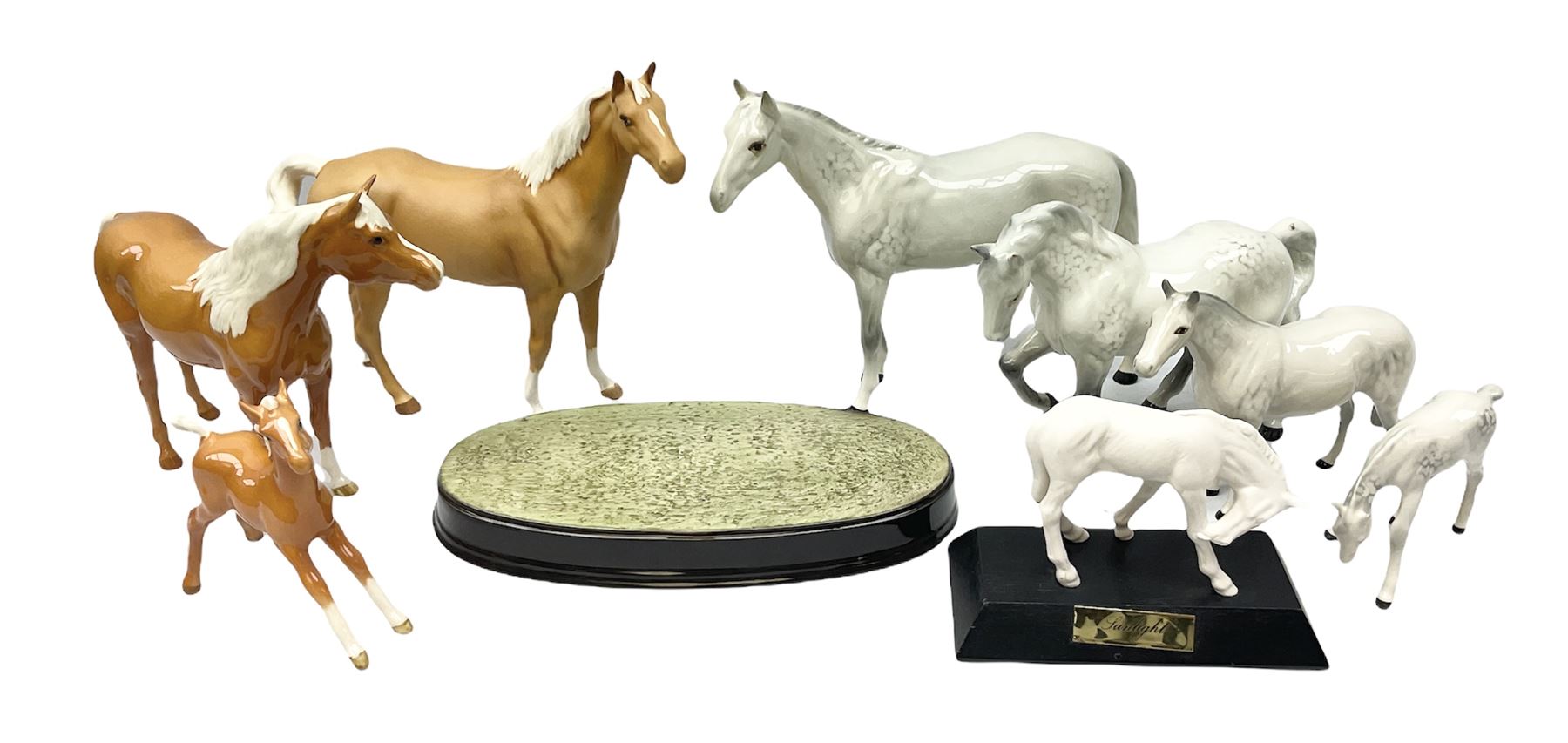 Collection of Beswick horses, including grey horse no.701, palomino foal no 836, grey stocky jogging mare no.855 etc, together two Royal Doulton horses, (8)