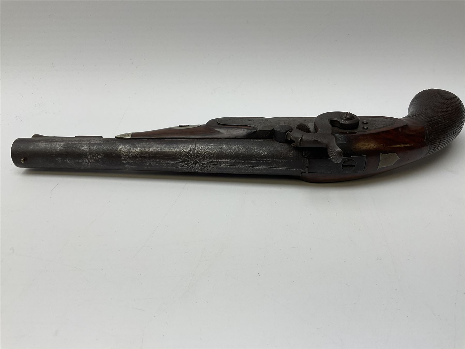 19th century flintlock converted to percussion cap target pistol, the 20.5cm barrel engraved with a sunburst motif to the top and ramrod under, foliate engraved lock-plate and trigger guard, silver plated fittings, walnut stock with chequered grip and melon fluted butt L35.5cm overall