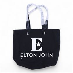 Elton John Farewell Yellow Brick Road tour merchandise, comprising programme, tote bag and VIP giftset with lanyard, wallet, luggage tag and keyring, in white box with gilt lettering, together with two limited edition Farewell Yellow Brick Road lithographs