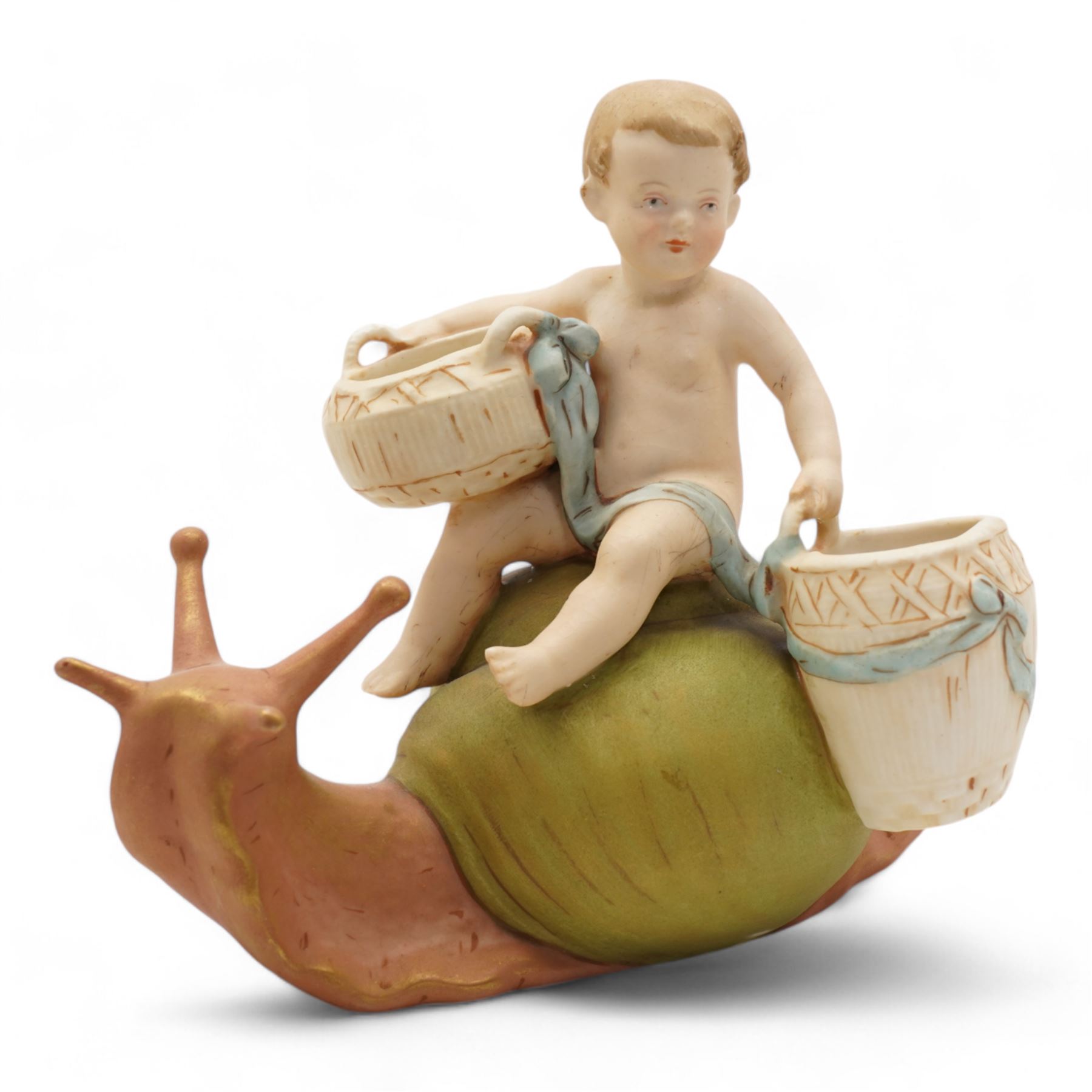 Royal Dux figural posey holder, modelled as a boy with baskets riding a snail, H16.5cm