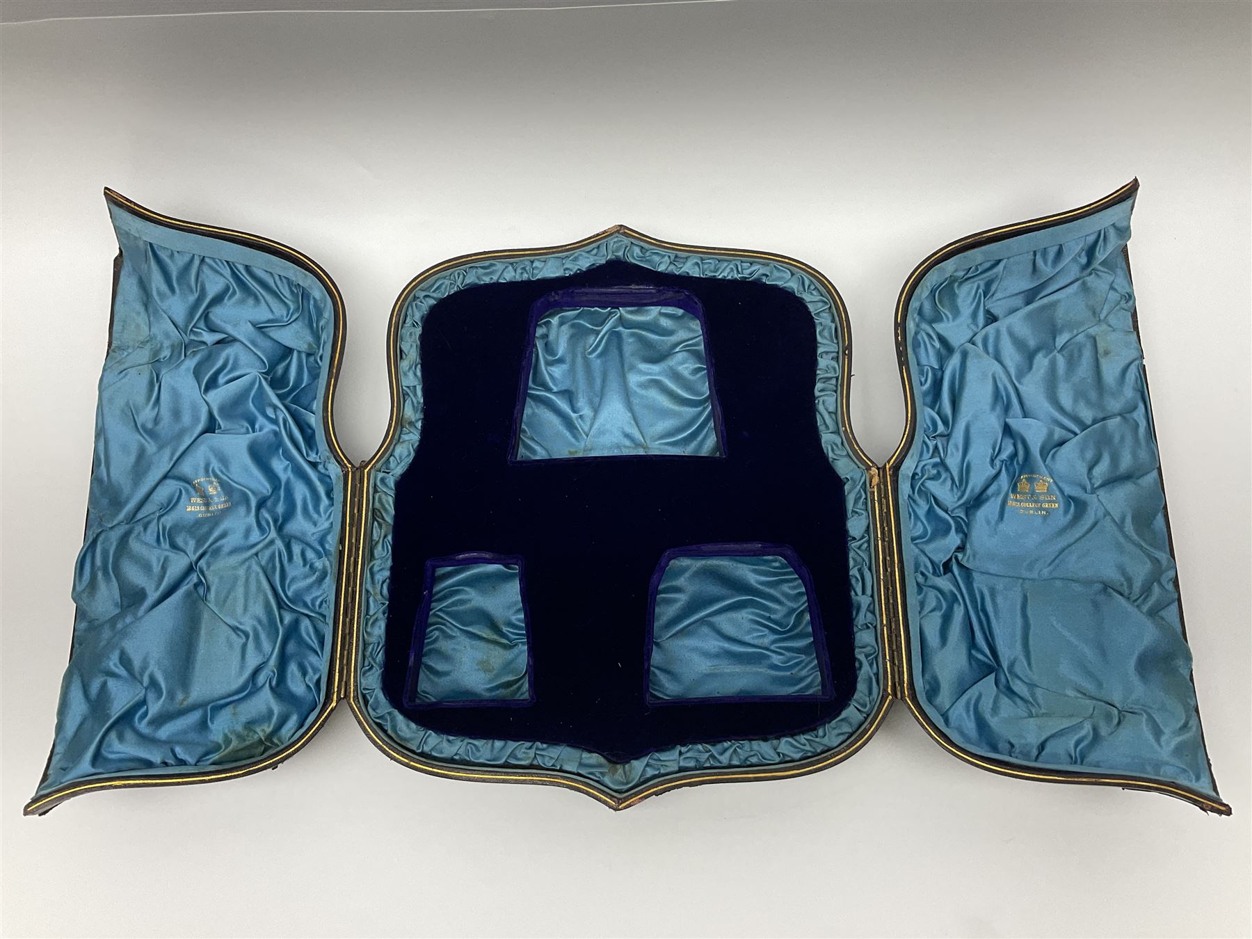 Victorian three-piece silver tea service, comprising teapot, twin handled open sucrier and milk jug, of oval form with shaped rim and C handles, each engraved with crests and bands of strapwork decoration, the milk jug and sucrier with gilt interiors, hallmarked Josiah Williams & Co, Exeter 1881, the teapot with ivory insulators and finial, all contained with a tooled leather, blue silk and velvet lined fitted case, retailed by West & Sun, Dublin 
This item has been registered for sale under Section 10 of the APHA Ivory Act