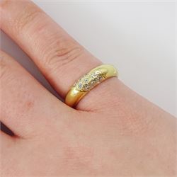 Gold diamond ring, rubover set with nine round brilliant cut diamonds