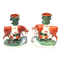  Pair Victorian Staffordshire spill vases each surmounted with the model of a cow and suckling calf, H26cm   