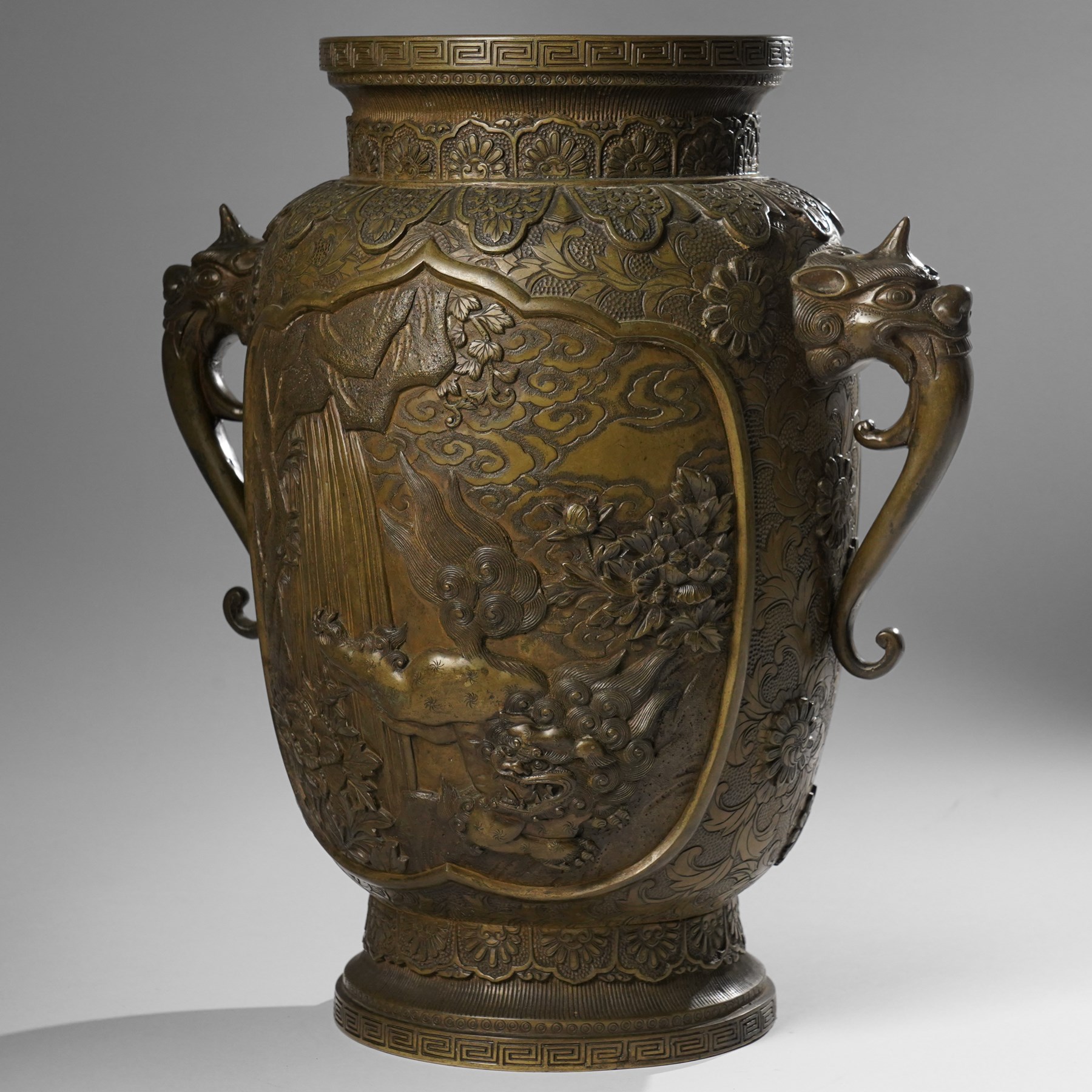 Japanese Meiji-Taisho period bronze vase, by Kanaya Gorosaburo, decorated with dragons and other creatures in a landscape, seal mark to base, H35.5cm 