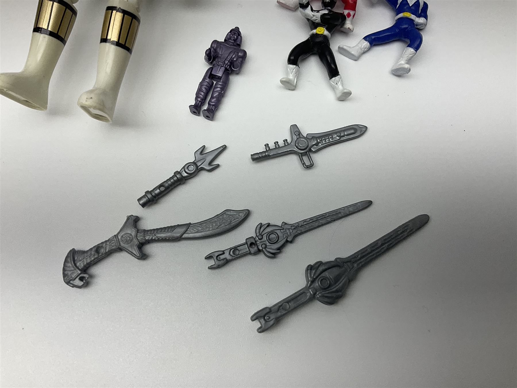 Collection of early 90s Mighty Morphin’ Power Rangers Zords, figures and accessories. Titanus the Carrier Zord, marked Bandai 1991; Green Dragonzord, incomplete; 1994 White Tigerzord with original instruction manual; 1993 Triceratops Dinozord, Mastodon Dinozord and Sabertooth Tiger Dinozord, Pterodactyl Dinozord, missing guns; with 1993 Power Morpher and original Power Coins, with further related figures, accessories and weapons