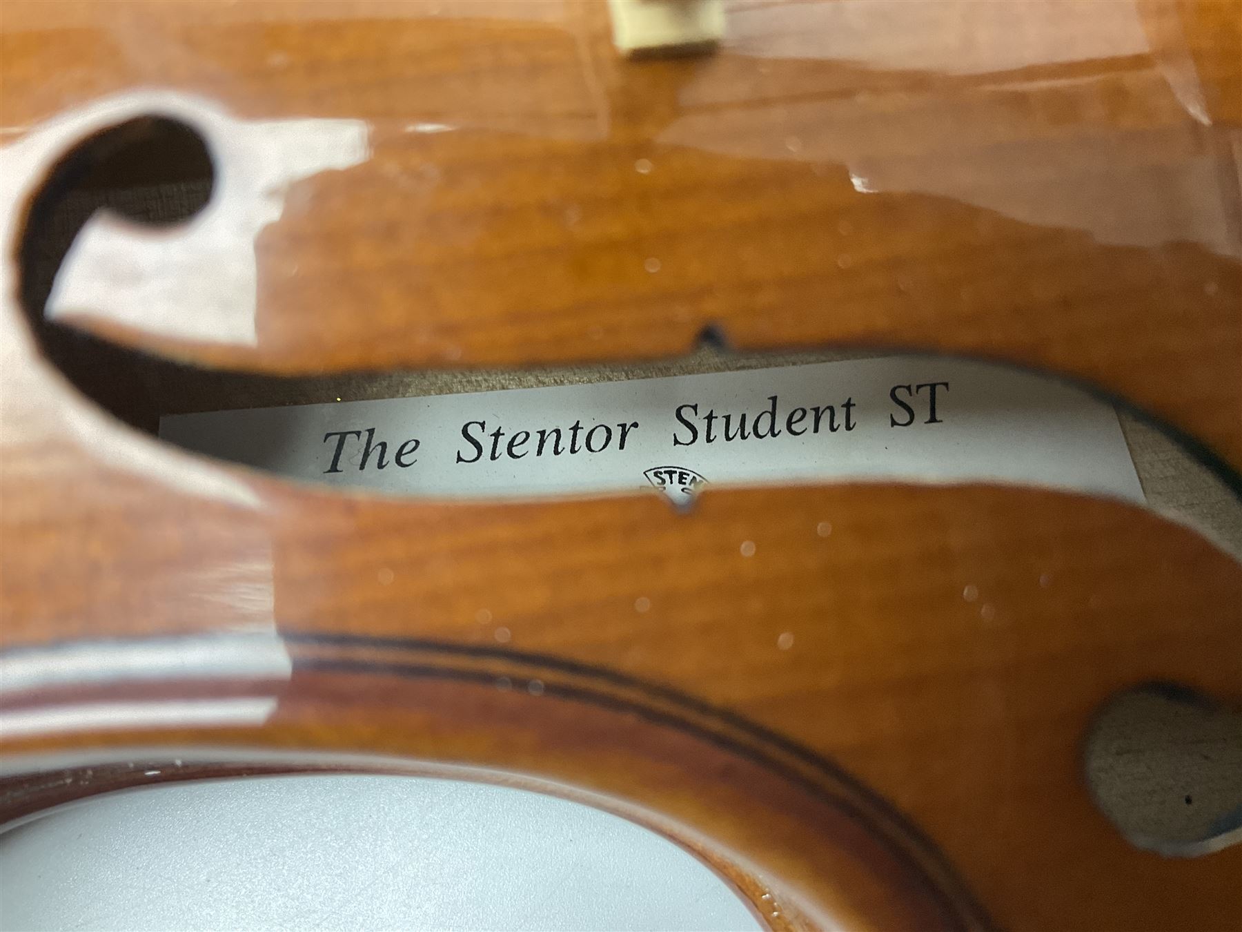 Three Stentor Student violins - three-quarter size with 33cm two-piece back; and two quarter size each with 28cm two-piece back; each in carrying case with bow (3)