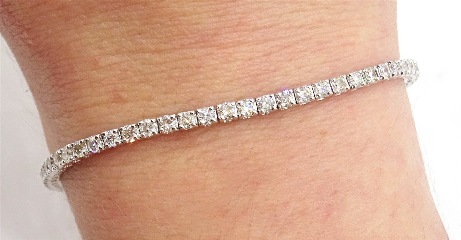 White gold diamond line bracelet, stamped 18K, total diamond weight 2.