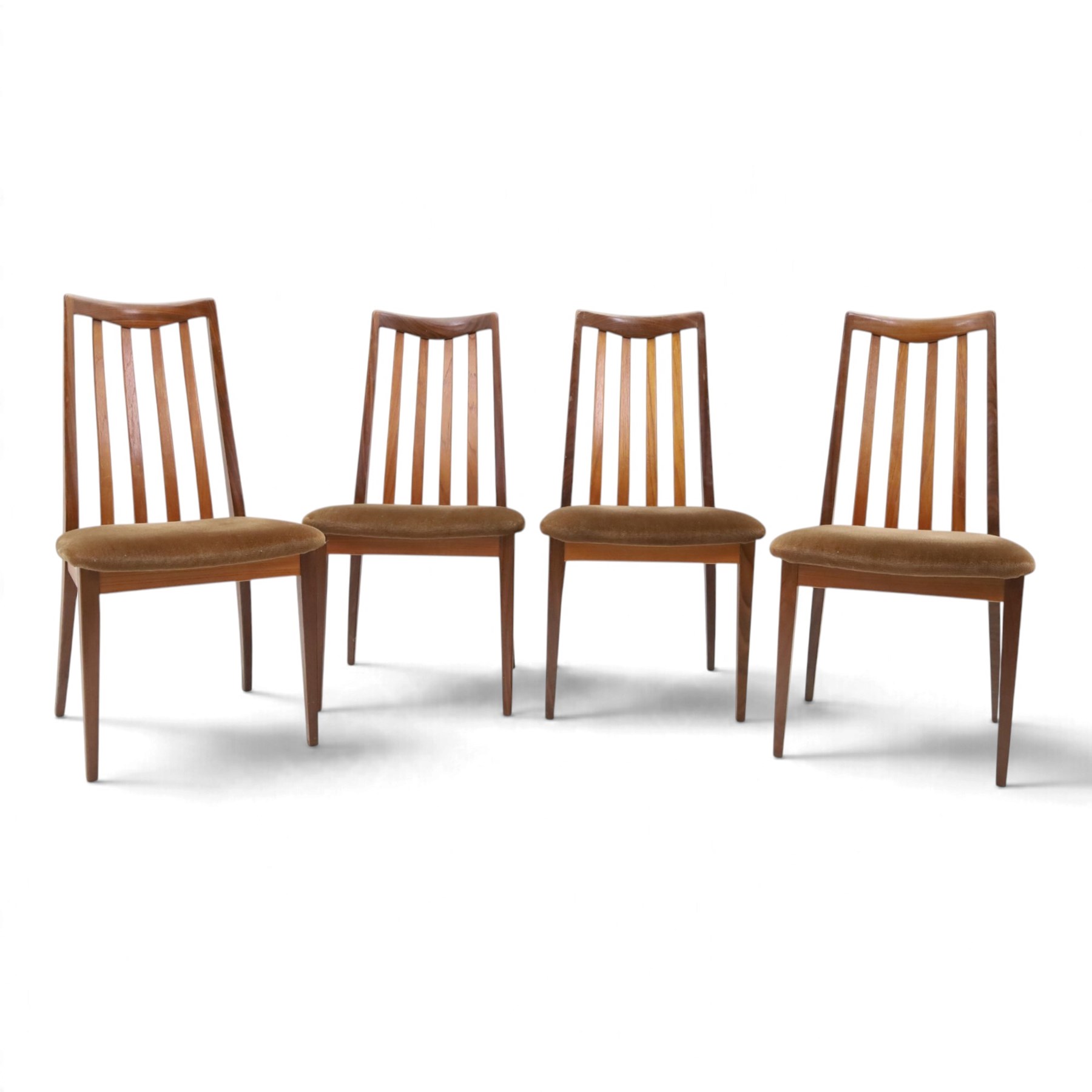 G Plan - Mid 20th century teak extending dining table and four chairs, oval top with stowed fold-over leaf extending to 208cm, raised on two shaped supports united by a stretcher 