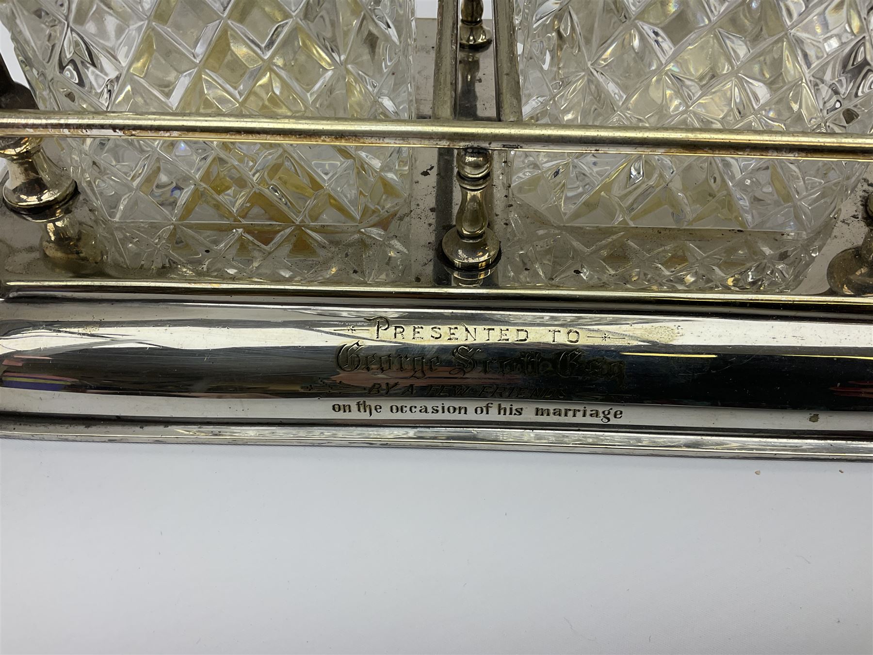 Early 20th century silver plated tantalus by John Grinsell & Sons of Birmingham, containing two crystal glass decanters, with key, H31cm