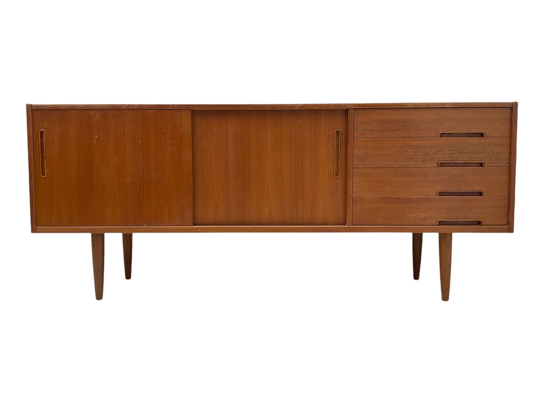 Nils Jonsson - mid-20th century teak sideboard, rectangular top over three-section base, left and centre sections with sliding double doors enclosing shelving, right section with four drawers, raised on tapered supports