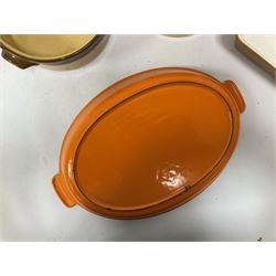 Le Creuset orange enamelled cast iron twin handled oval dish, together with other ceramic cookware 