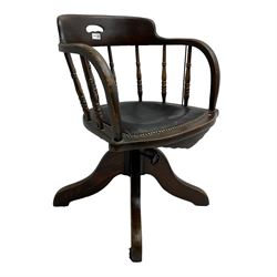 Early 20th century oak framed swivel and tilting Captain's chair, tub shaped back with spindle supports over leather seat