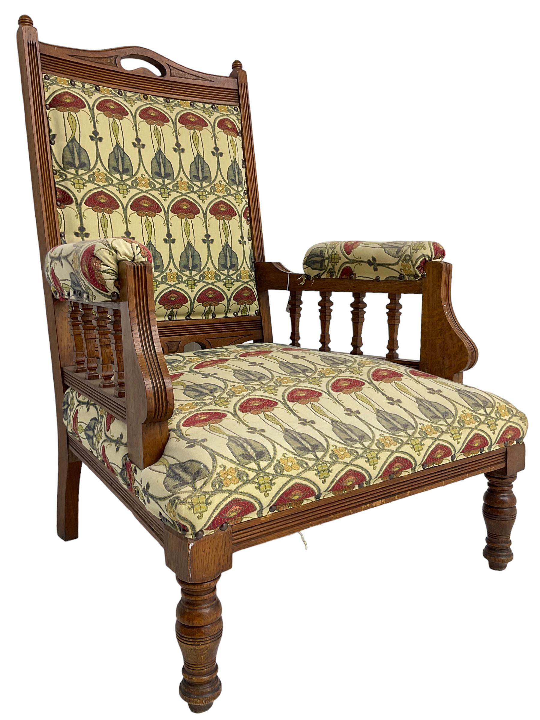 Early 20th century armchair, back and sprung seat upholstered in Art Nouveau patterned fabric, raised on ring turned supports, the frame with all-over reeded decoration