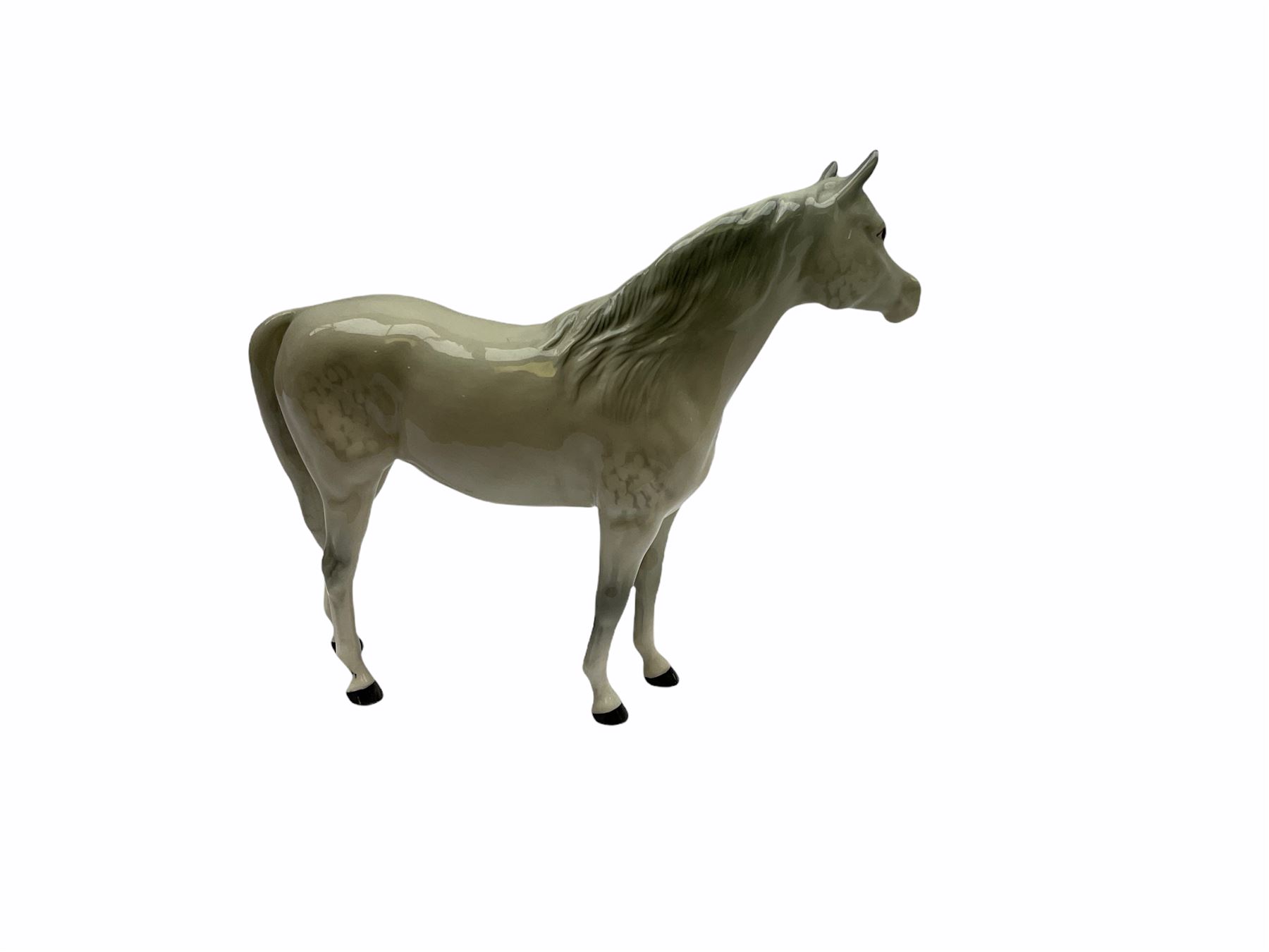 Beswick horse figures, comprising Highland Pony 1644, and another, probably Aran Bahram in grey, each with printed mark beneath.
