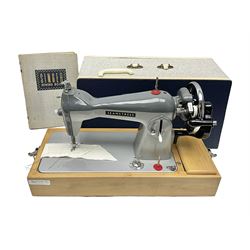Seamstress sewing machine in case, together with a Singer sewing book