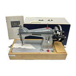  Seamstress sewing machine in case, together with a Singer sewing book