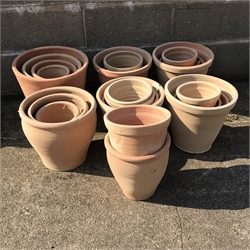 A quantity of approx. 24 tapering terracotta plant pots - various sizes