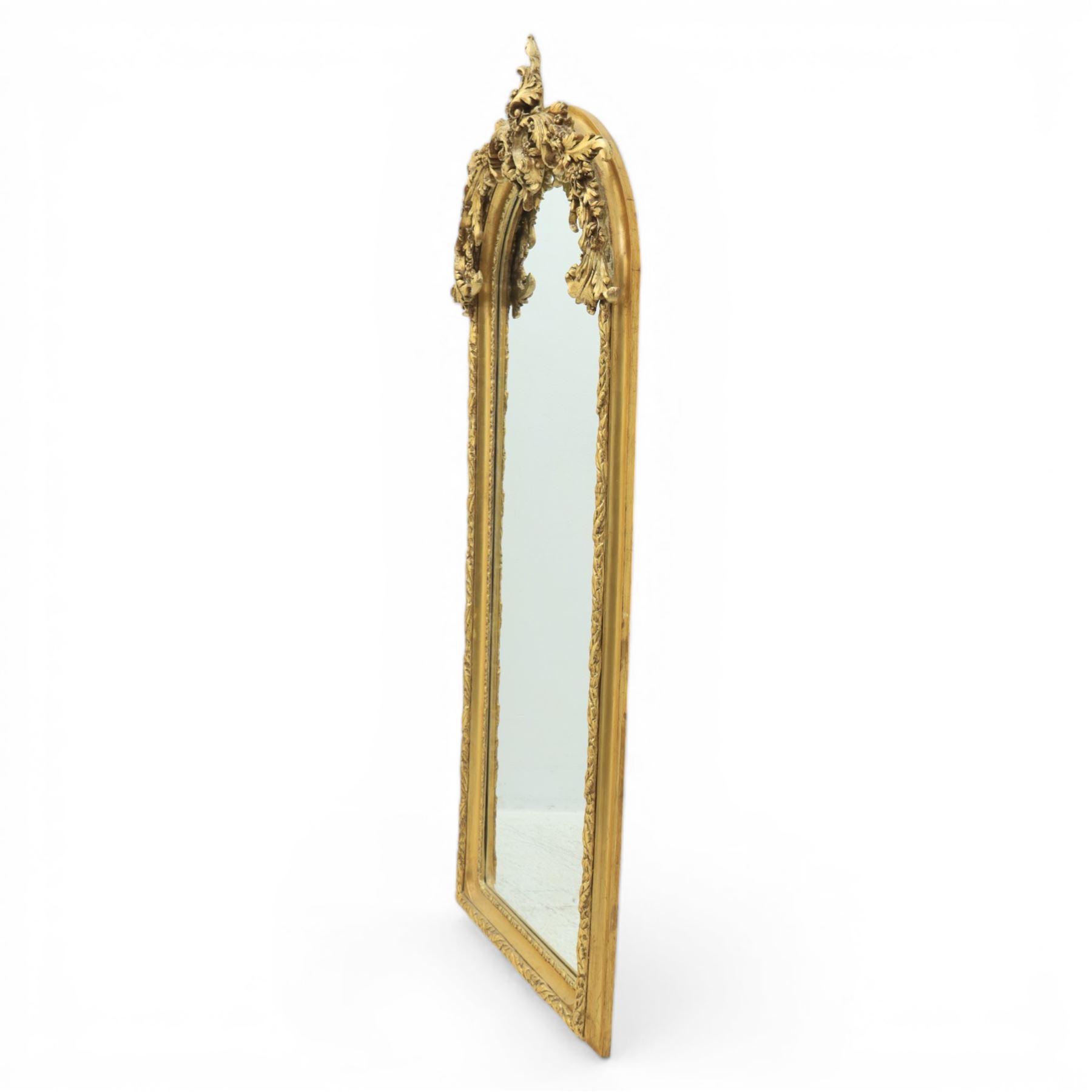 Pair of Louis XV style giltwood overmantel mirrors, the arched rectangular frame surmounted by an elaborate pierced cresting of acanthus scrolls, rocailles and floral swags, the moulded frame with continuous foliate carving and beaded inner slip