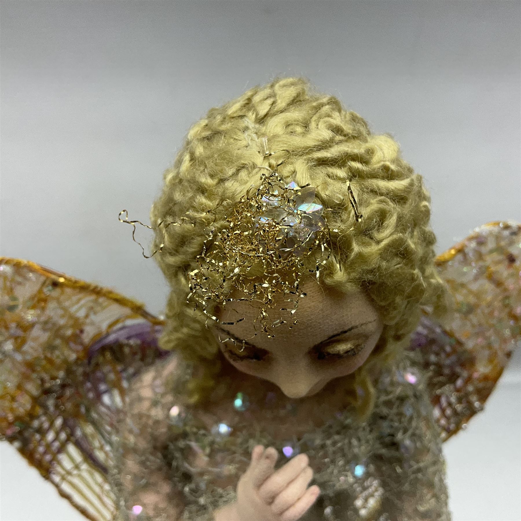 Anna Meszaros Hungary - hand made needlework figurine of an Angel with metallic lace full length dress and open threadwork wings; on moulded base H45cm Auctioneer's Note: Anna Meszaros came to England from her native Hungary in 1959 to marry an English businessman she met while demonstrating her art at the 1958 Brussels Exhibition. Shortly before she left for England she was awarded the title of Folk Artist Master by the Hungarian Government. Anna was a gifted painter of mainly portraits and sculptress before starting to make her figurines which are completely hand made and unique, each with a character and expression of its own. The hands, feet and face are sculptured by layering the material and pulling the features into place with needle and thread. She died in Hull in 1998.