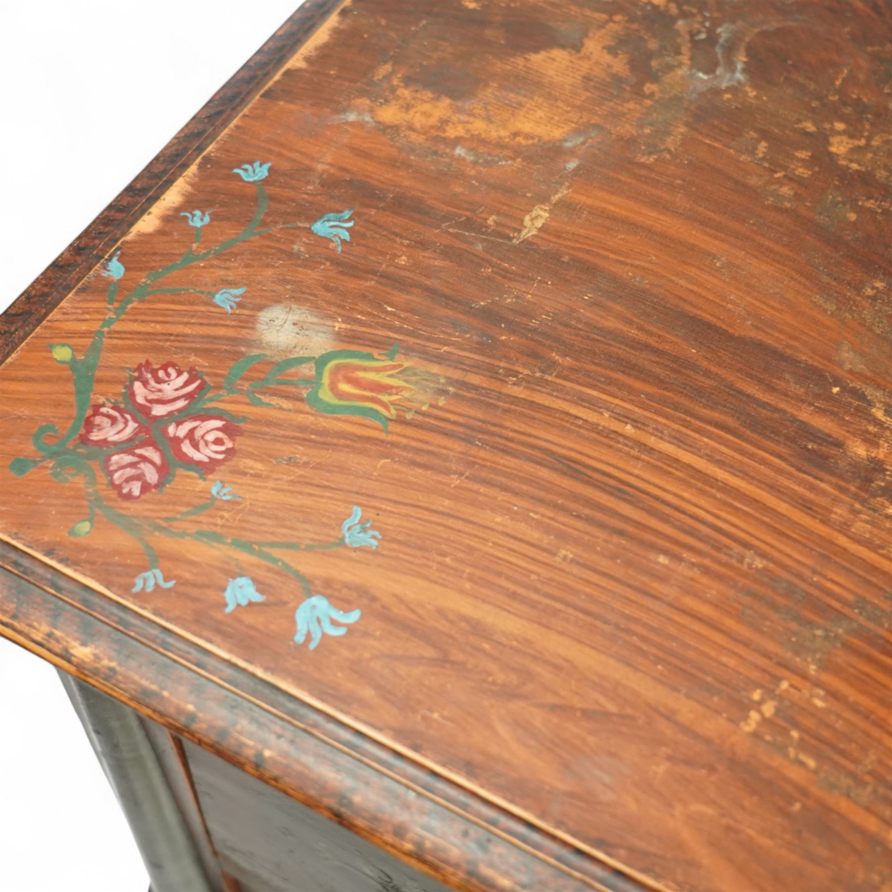 19th century painted pine chest of drawers, the rectangular top with moulded edge and painted floral decoration, above three drawers with later ceramic handles, with half turned column and reeded pilasters, upon turned compressed bun feet  