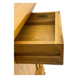 Frank Hudson - contemporary pair of light oak bedside cabinets, each with moulded rectangular top over single drawer above cupboard door with arched panel, on a moulded plinth base with bracket feet
