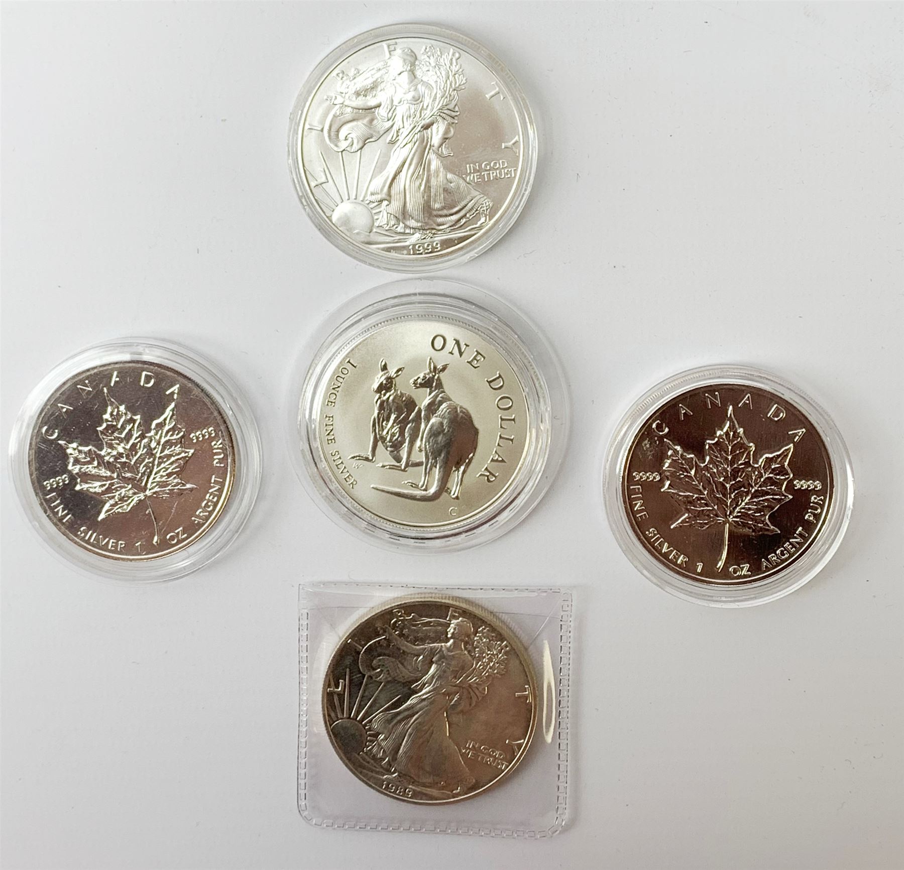 Five silver bullion coins, each containing one troy ounce of fine silver