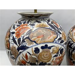 Pair of large and impressive 20th century Japanese Imari table lamps, each of ovoid form, decorated in the Imari palette with roundels containing flowering urns, and shaped panels of birds, set against a white ground decorated with blossoming peonies, lamp base (not including fixtures) H56.5cm overall including shade H89cm