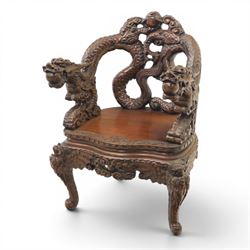 Chinese carved hardwood dragon throne chair, the shaped and pierced back with entwined dragons and cloud motifs, sweeping dragon-form arms terminating in carved heads, solid panel seat over foliate carved apron, on four mask carved cabriole supports
