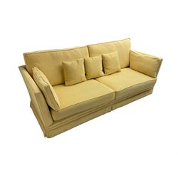 Large four seat sofa (W228cm, D95cm, H93cm), and matching armchair (W105cm, D95cm), upholstered in pale pastel yellow fabric
