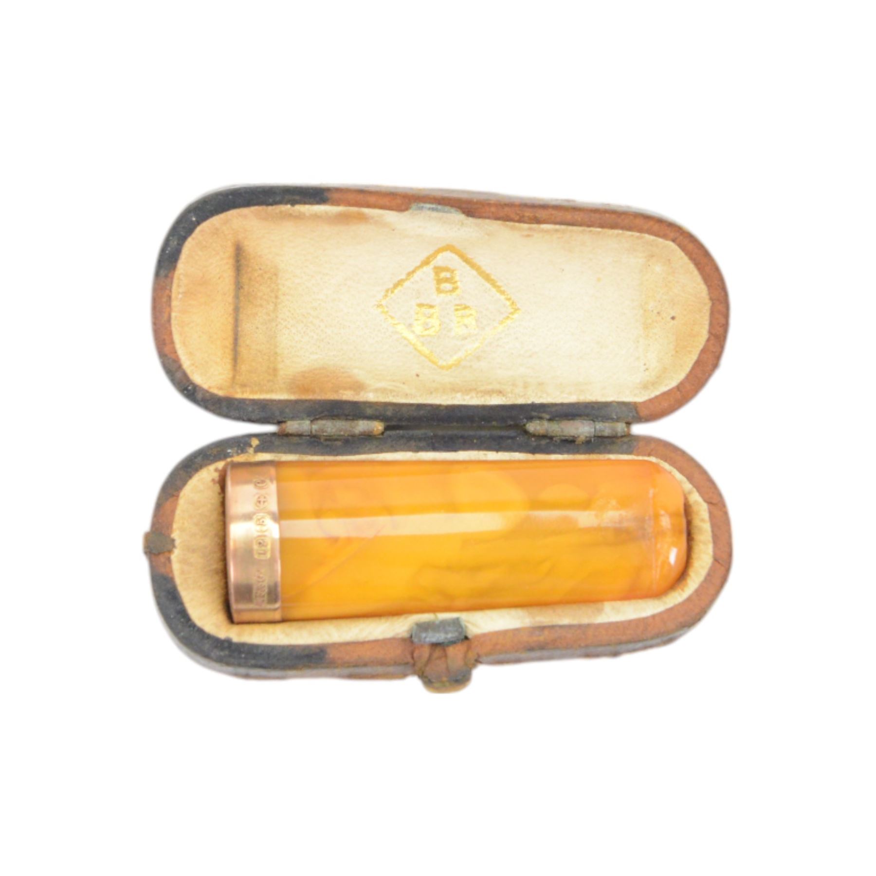 Amber gold mounted cheroot holder, 12.5 ct hallmarked, cased, together with another gold mounted example and various others, and silver mounted pipe 