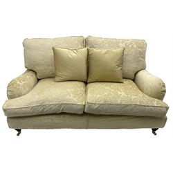 Multi-York - Howard shape two-seat sofa, upholstered in scrolling floral pattern loose covers, rolled arms, on turned front feet with brass cups and castors