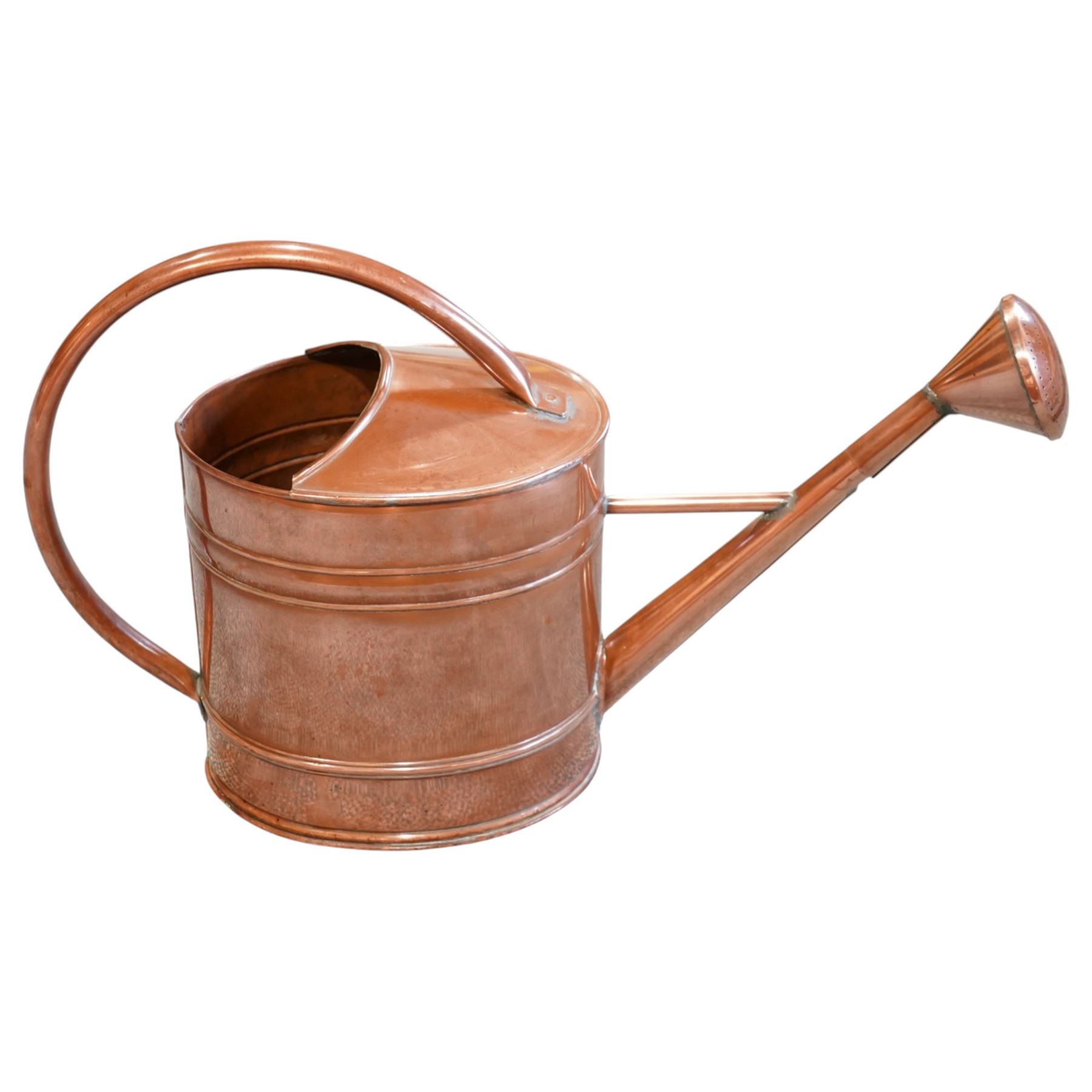 19th century copper watering can, with a looping handle and a rose to the end of the spout