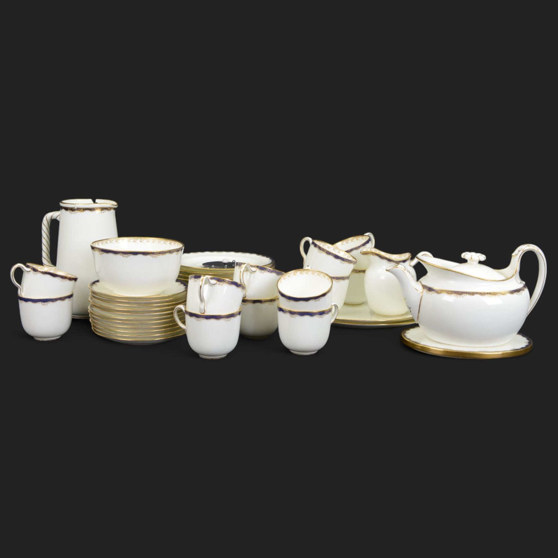 Wedgwood tea service, comprising teapot and stand, hot water jug, milk jug, open sucrier, twelve side plates, two sandwich plates, twelve cups and eleven saucers 