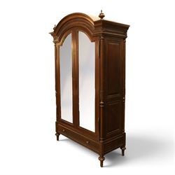 And So To Bed - French design ‘Eclectic’ double wardrobe in dark finish, arched moulded cornice with carved foliate band and turned finials, two mirrored doors enclosing a hanging rail, flanked by turned columns with foliate decoration, single fluted drawer below, on turned tapering feet