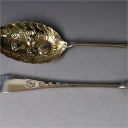 Mid 20th century silver berry spoons, each with gilt bowls embossed with fruit, with Queen Elizabeth II Coronation hallmark for C J Vander Ltd, London 1952, L22cmcm