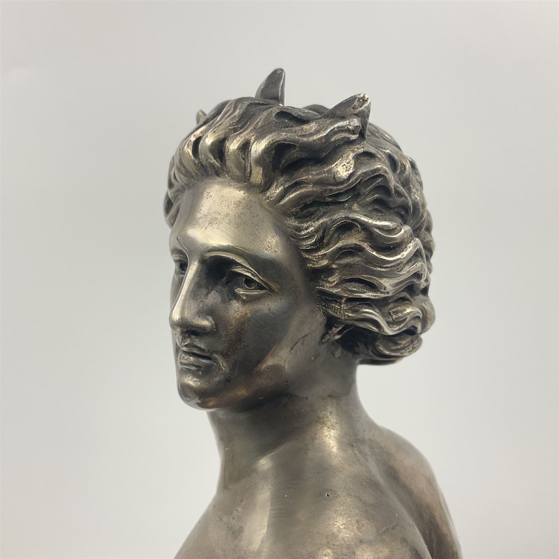 20th century silver plated figure, modelled as a classical male figure, possibly Prometheus, holding flames, one foot resting atop a small dragon, upon a circular spreading base, overall H37.5cm