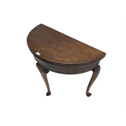 Early 20th century walnut demi-lune side table, fold-over top with hinged storage compartment, on cabriole supports with pointed pad feet, single gate-leg action base