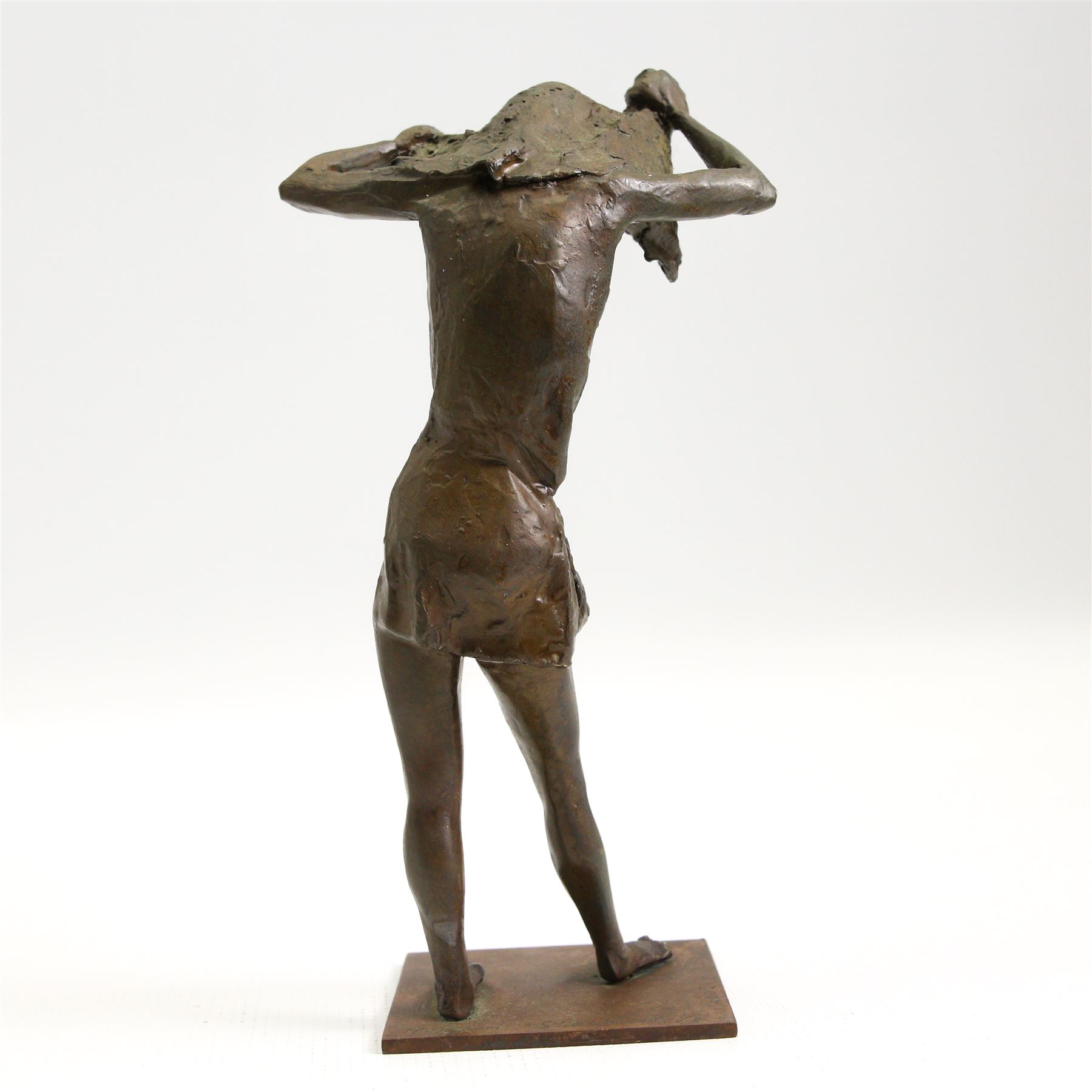Hylton Stockwell (British): Limited edition bronze sculpture of a woman pulling a shirt over her head, signed and dated 2002, 2/4, H22cm