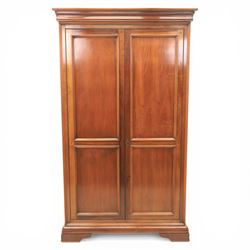 Willis & Gambier - French cherry double wardrobe, moulded cornice above panelled doors, enclosing a shelf and wooden hanging rail, raised on a moulded plinth with bracket feet