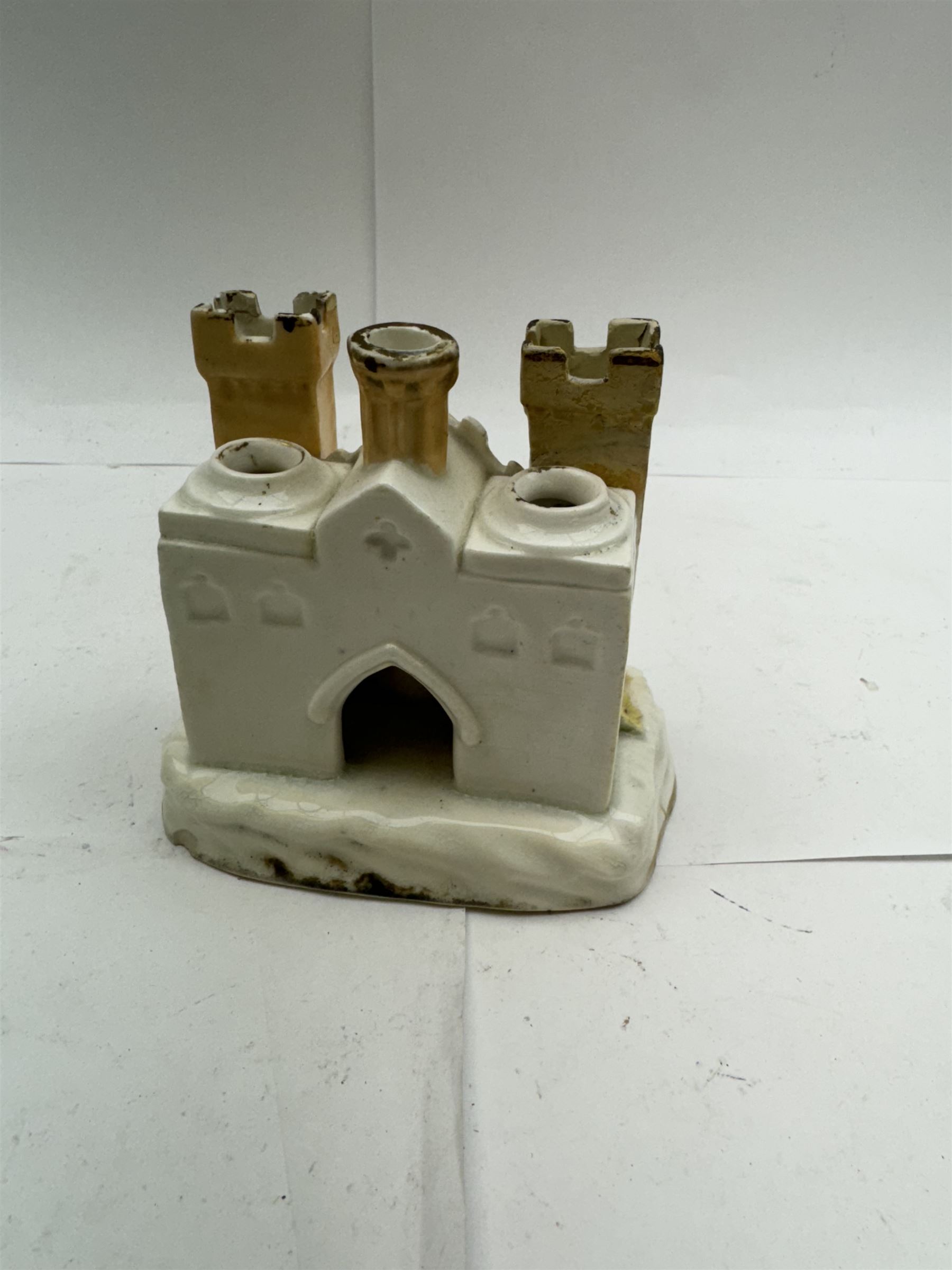 Pair of Staffordshire figures modelled as chained Dalmatians seated upon cobalt blue oval bases, H13cm, together with a Staffordshire pastille burner modelled as a castle, H12cm, a pair of 19th century Derby potpourri pots (lacking covers), and an 18th century blue and white tea bowl 