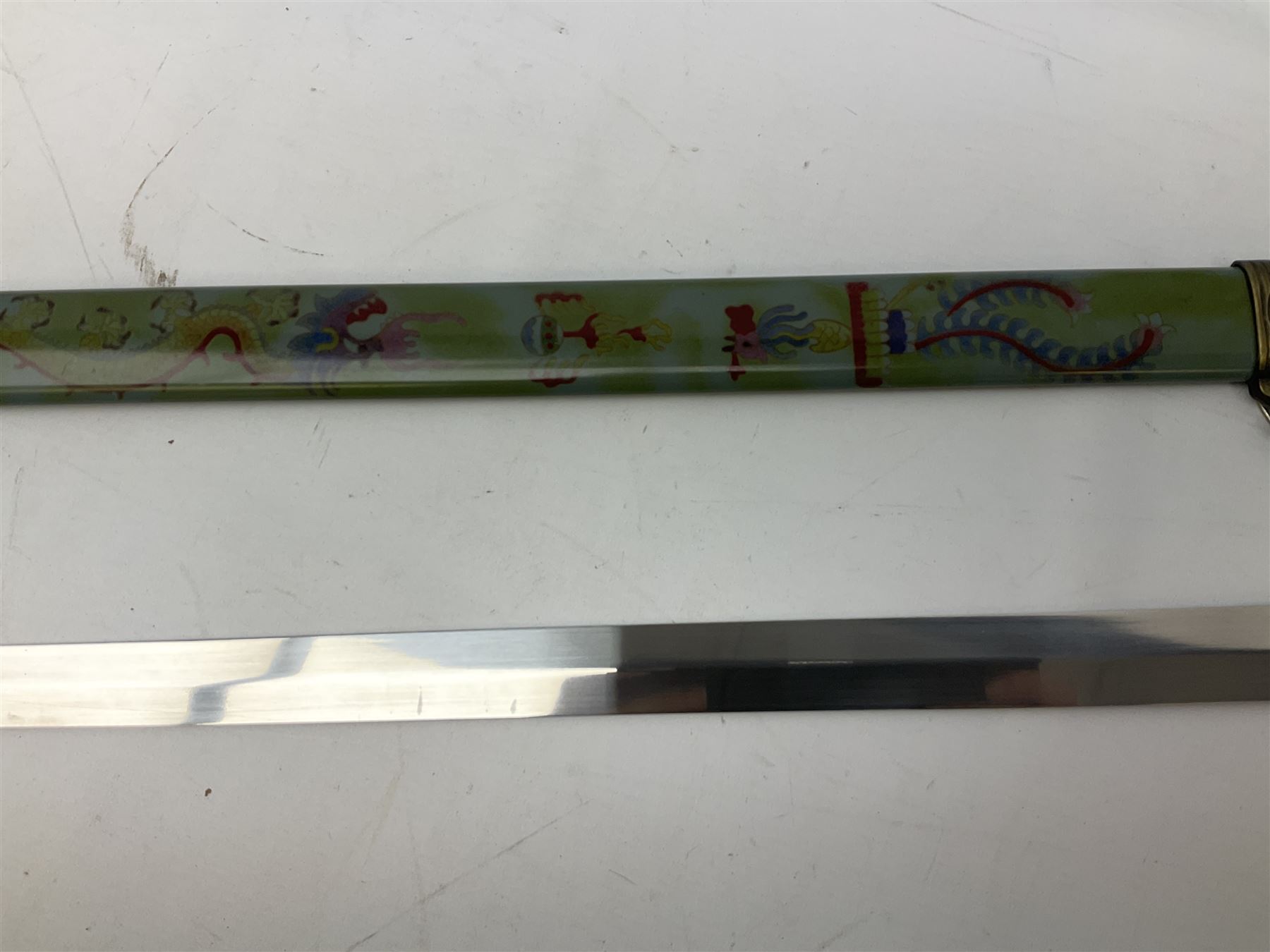 Three reproduction swords - Japanese katana and saya; Tai Chi sword with ornate scabbard; and dress sword with fullered triangular blade and horn handle (3)