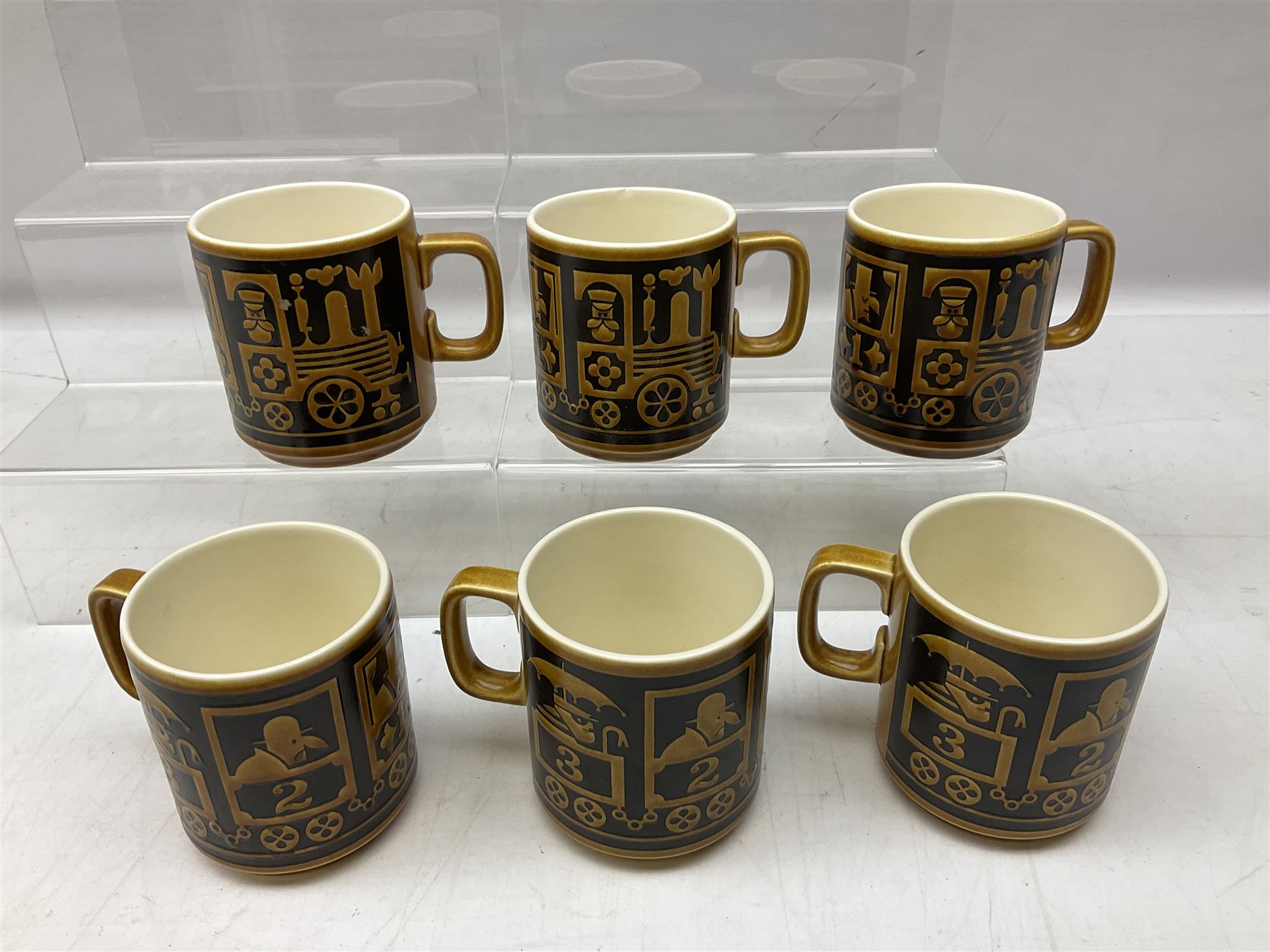 Collection of 1970s Hornsea mugs designed by John Clappison, comprising six Train Robber pattern examples together with owl patterned example on dark teal ground, and further example decorated with stylised hen and chick and egg, approx 9cm, together with four small cup bowls, all with stamped Hornsea marks beneath