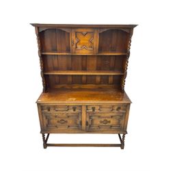 Early 20th century oak dresser, two-tier plate rack fitted with central cupboard and flanked by spiral turned uprights, base fitted with two drawers over two cupboards with geometric moulded facias, raised on barley twist supports