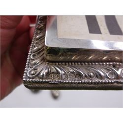 Group of silver, comprising Victorian silver mounted perpetual calendar with various date cards, hallmarked Henry Matthews, Birmingham 1900, silver mounted dressing table items, to include hair brush, with embossed decoration, pair of clothes brushes, and a shoe horn, together with a pair of silver mounted dwarf candlesticks, four cut glass jars/scent bottles with silver covers and a cut glass open salt with silver collar, all hallmarked 