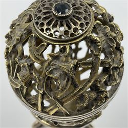 Modern silver limited edition Easter egg, no. 70/500, the gilt openwork body decorated with daffodils and detachable cover with pierced circular panel set with a single faceted blue stone, opening to reveal a gilt interior, upon silver stand with three scrolling pad feet, each hallmarked St James House Company, London 1980, height including stand 8cm
