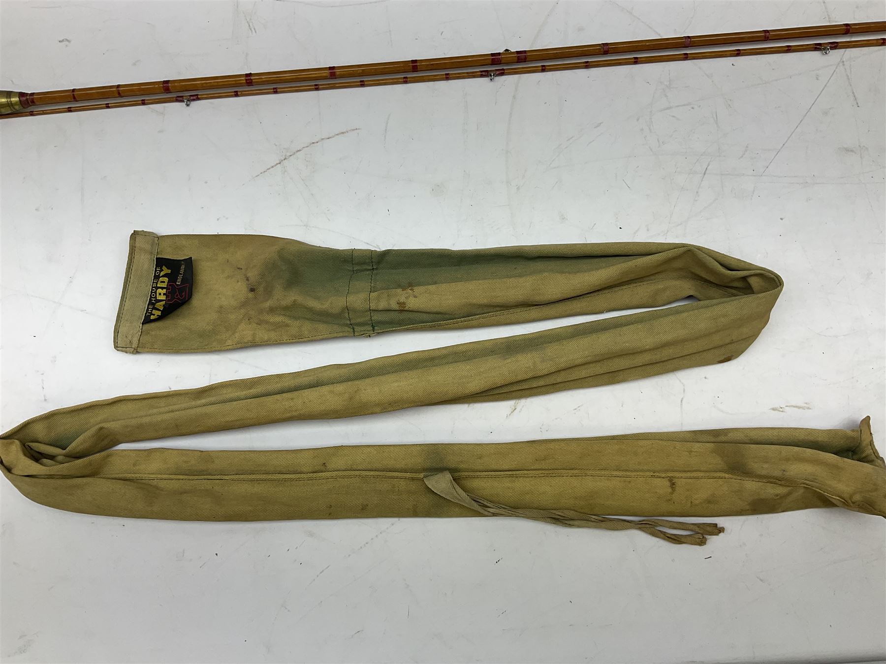 Hardy 'The Sir Edward Grey' two piece split can fishing rod, with cork handle and brass fittings marked Hardys, with a Hardy cover