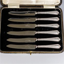 Set of six 1920s silver teaspoons with engraved initials, together with two sets of silver handled tea and fruit knives, all hallmarked and all within fitted cases
