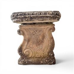 Weathered cast stone three-piece garden bench, with rectangular seat with egg-and-dart moulded edge, raised on end supports decorated with S-scrolls and fruiting vines