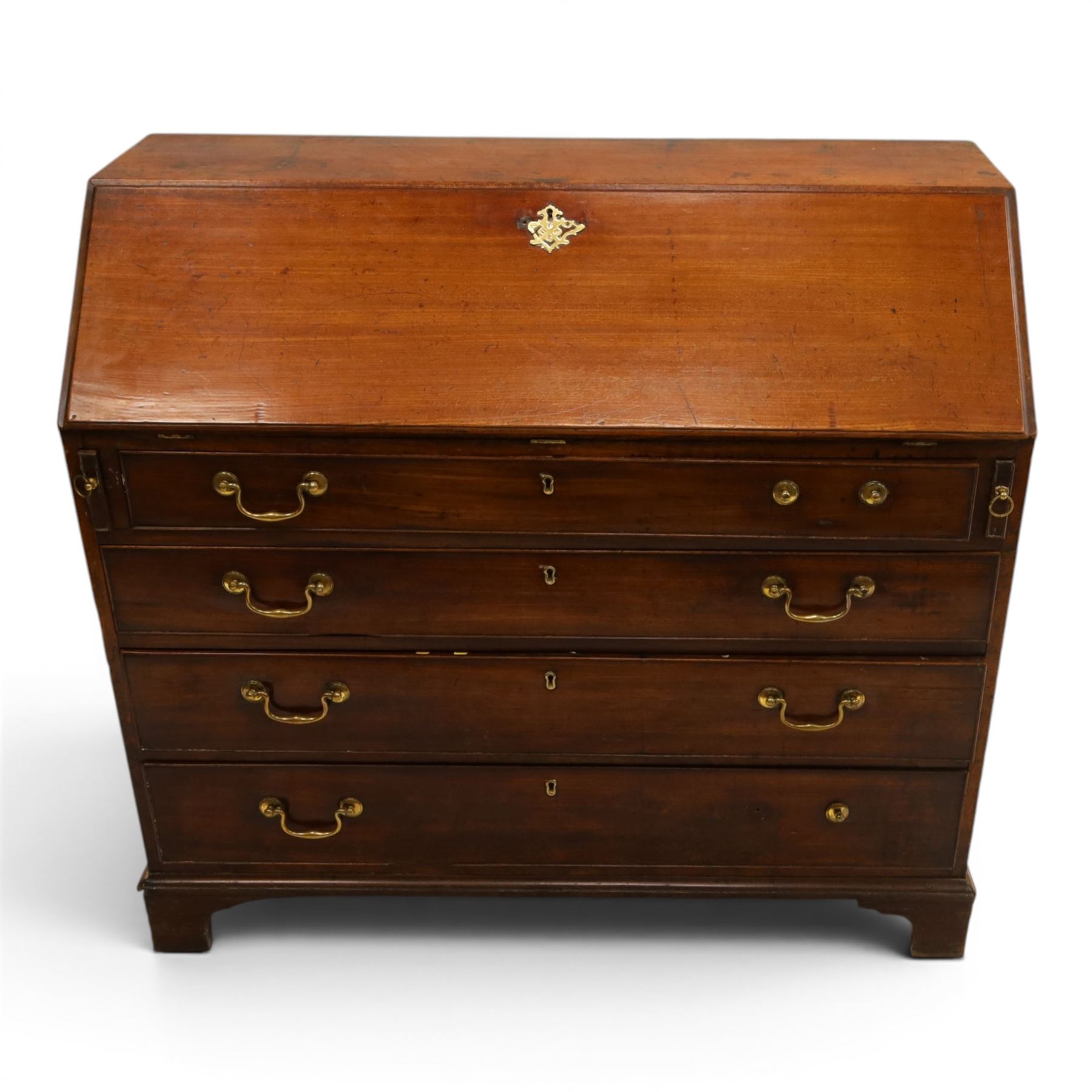 George III mahogany bureau of large proportions, the fall-front enclosing fitted interior with fluted column secret compartments and assorted pigeonholes and correspondence drawers flanking central cupboard, over four graduating cock-beaded drawers with original brass swan-neck handles, raised on bracket feet