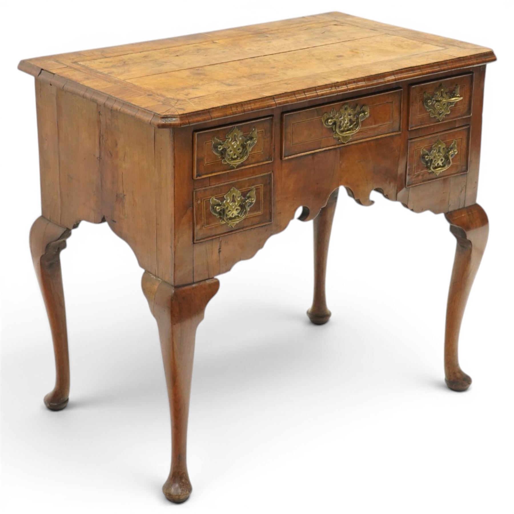 18th century figured and burr walnut lowboy, the rectangular canted top with book-matched veneer and crossbanding with moulded edge, fitted with an assortment of five cock-beaded drawers with original pierced brass handle plates, over a shaped apron, raised on cabriole supports with pad feet